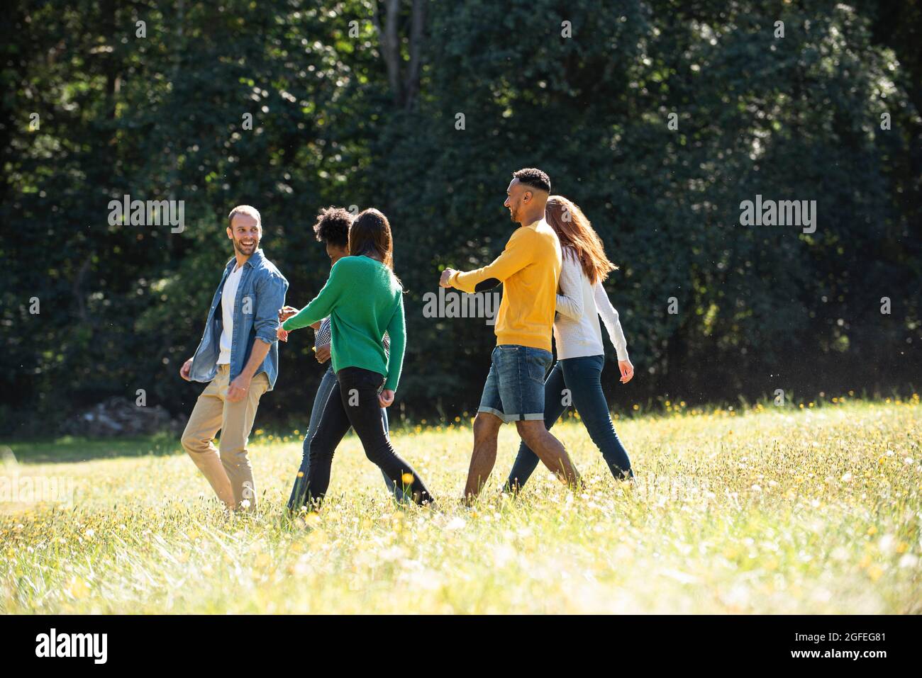 Friends walking together in the park hi-res stock photography and ...