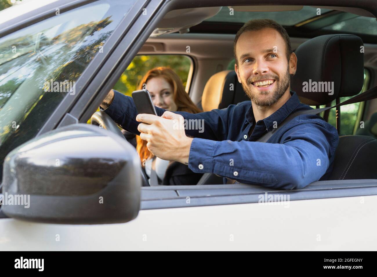 Smiling young couple enjoying road trip Stock Photo