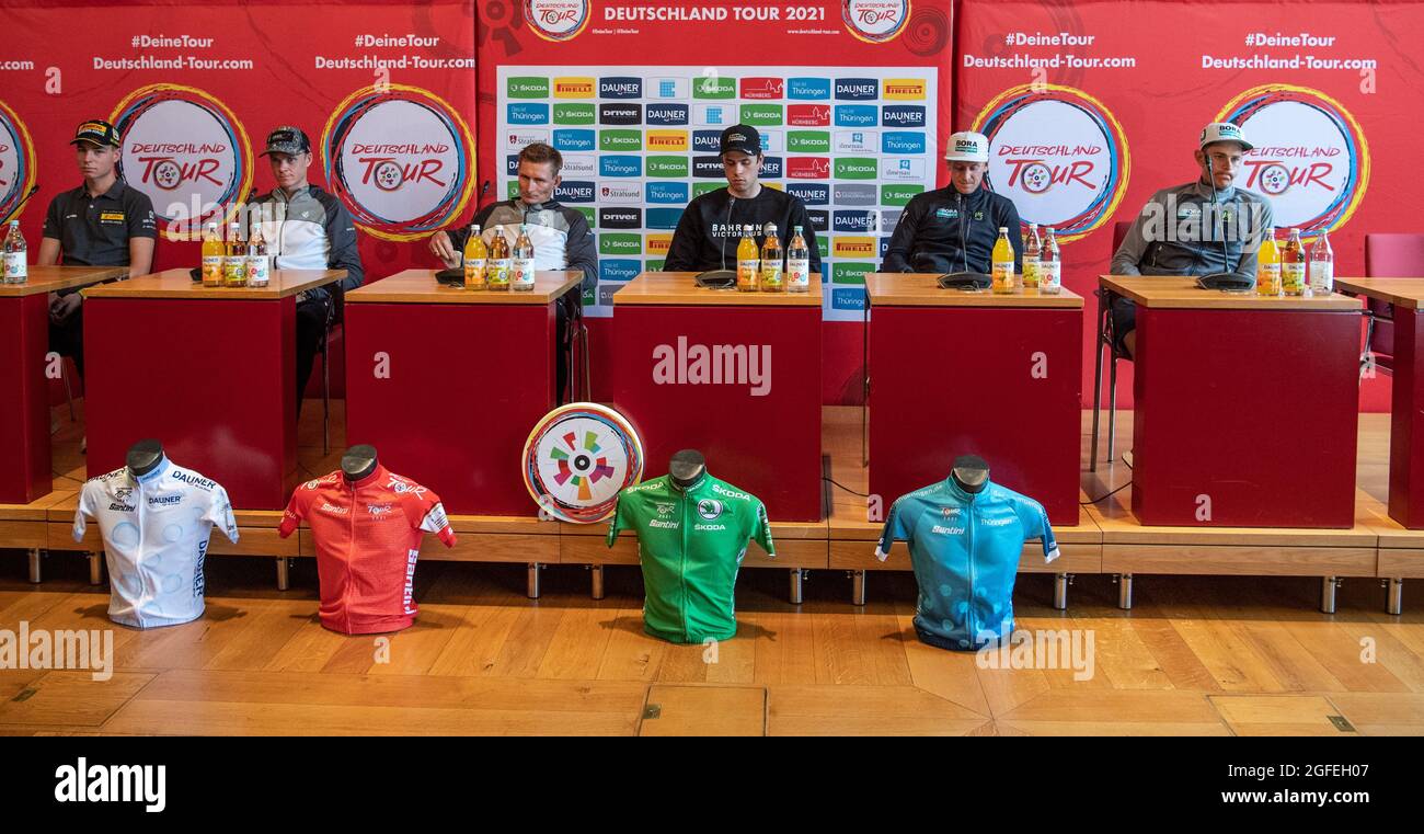 Stralsund, Germany. 25th Aug, 2021. Kim Heiduk of Team Lotto-Kern Haus (l) and Christopher Froome and Andre Greipel of Team Israel Start-Up Nation, Phil Bauhaus of Team Bahrain Victorious and Paul Ackermann and Nils Politt of Team Bora-hansgrohe (l-r) attend a press conference before the start of the Tour of Germany. Credit: Bernd Thissen/dpa/Alamy Live News Stock Photo