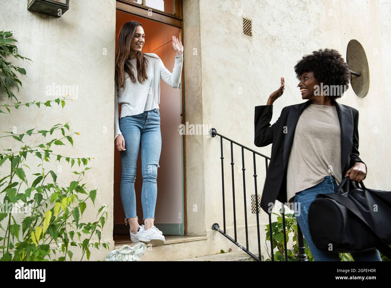 Waving door woman hi-res stock photography and images - Alamy