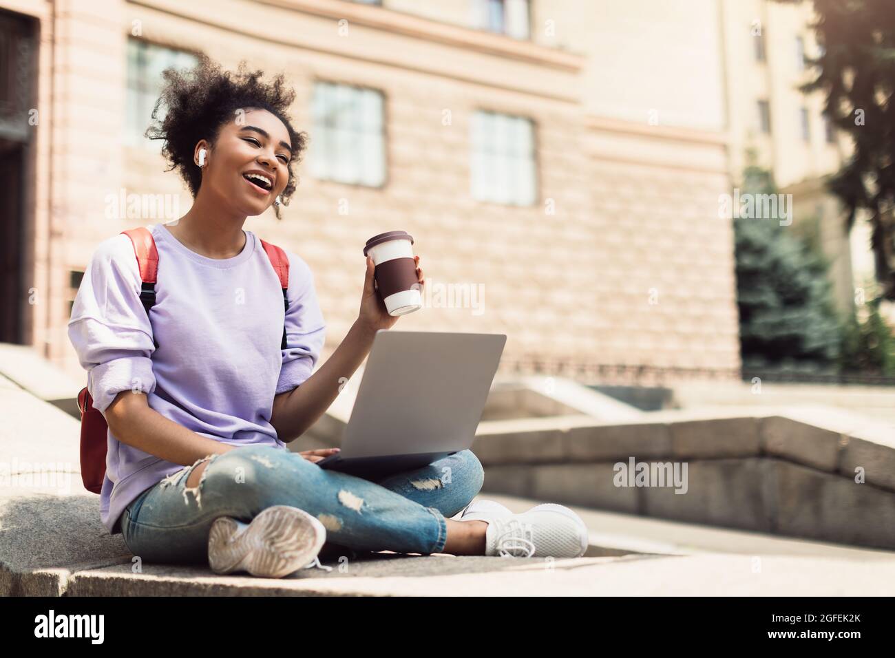 Cheerful Black Girl Chatting Via Video Call On Laptop Outdoor Stock Photo
