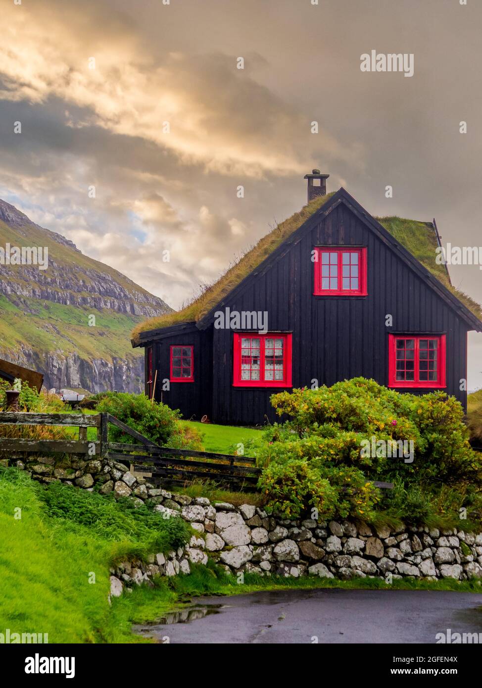 Kirkjubøur, Faroe Islands - October 2020: Typical wooden turf house with red window on Streymoy Island., Denmark, Northern Europe Stock Photo