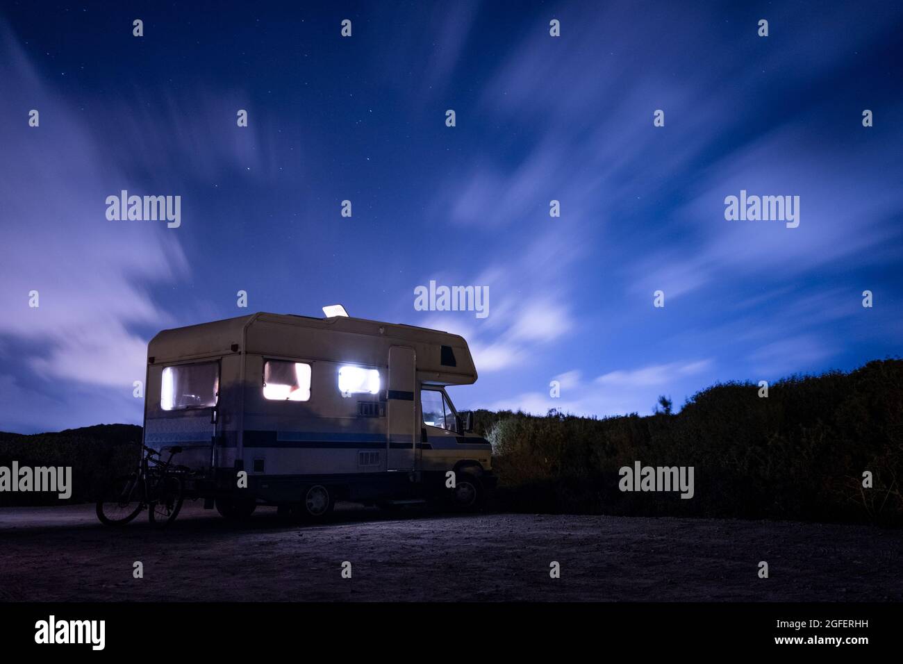 A luxury van under a starry sky