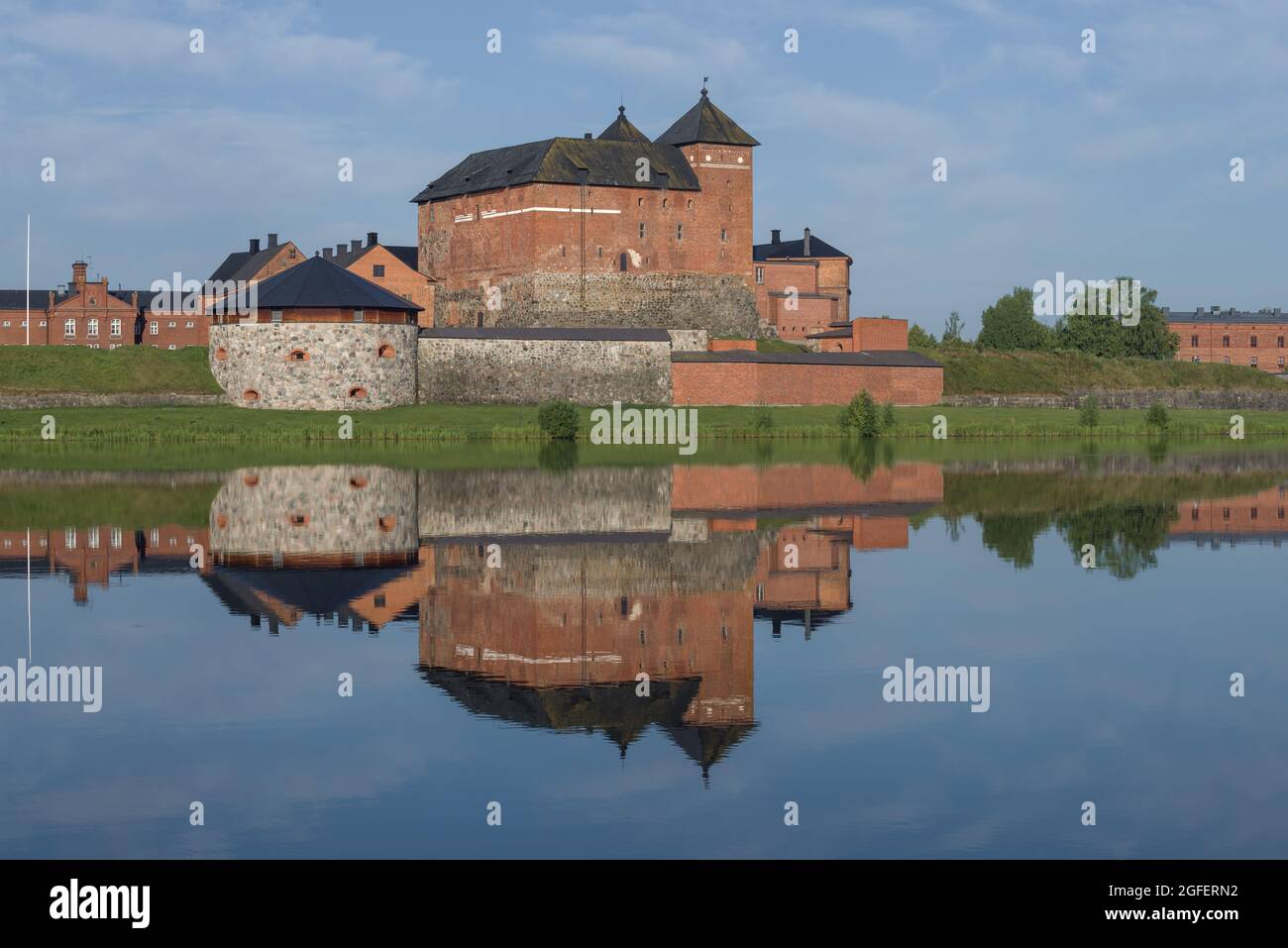 View of the ancient fortress-prison of the city of Hameenlinna on the shores of  Vanajavesi lake in the early July morning. Finland Stock Photo