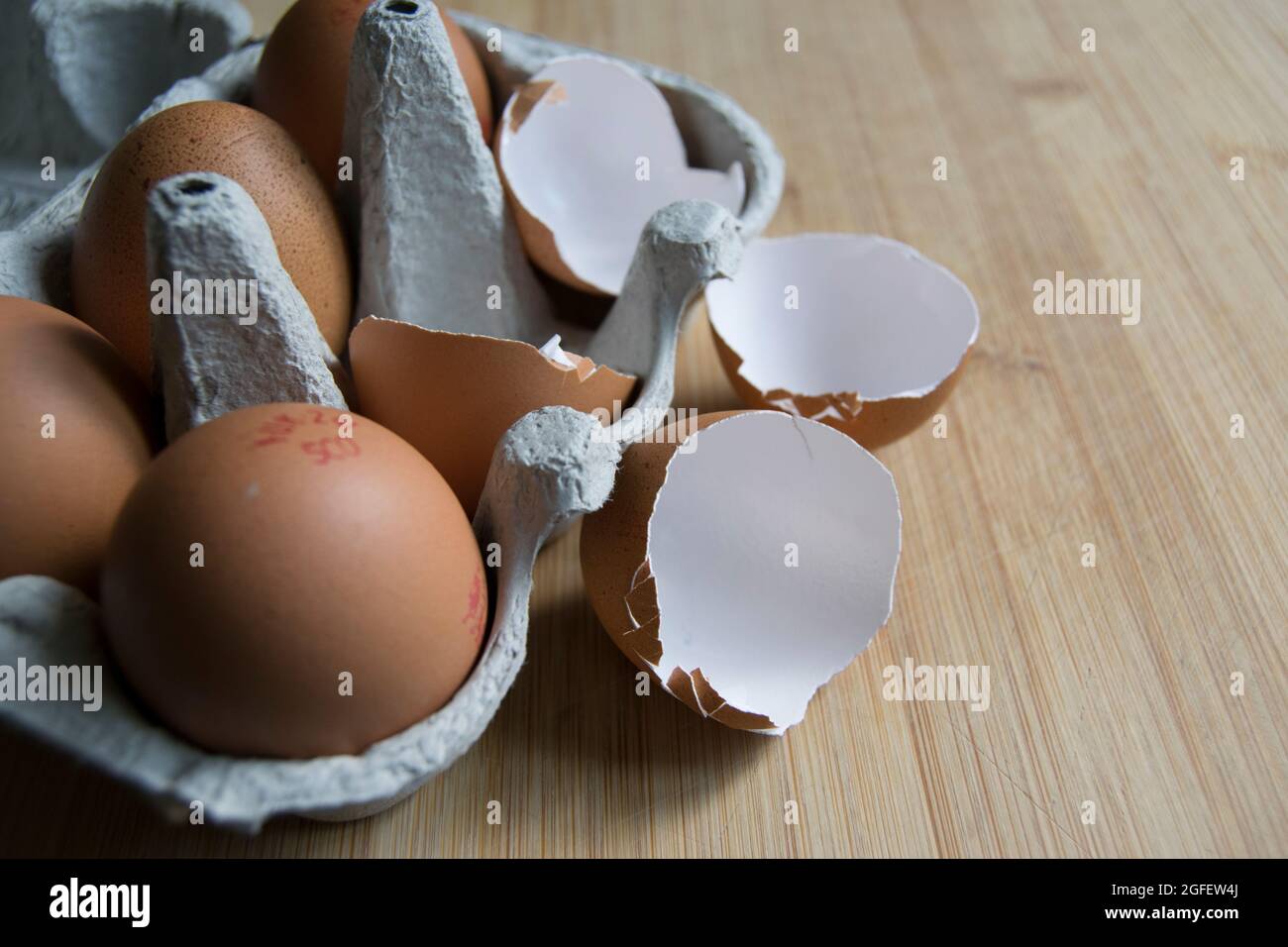Brown speckled empty eggshells on the kitchen worktop Stock Photo