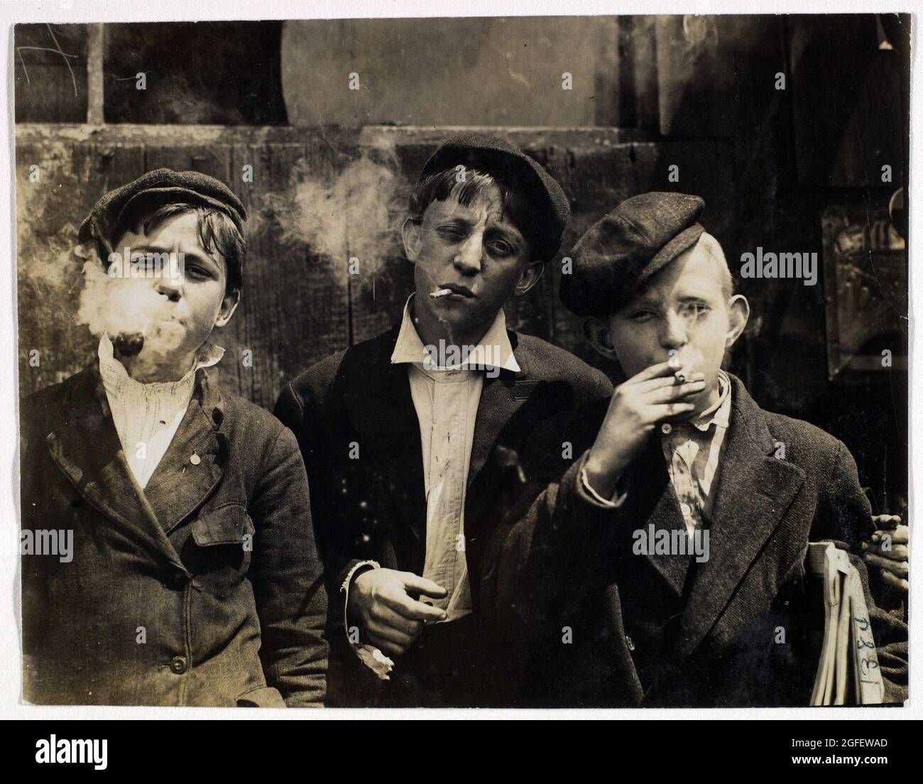 11.00 A.M. Monday, May 9th, 1910. Newsies at Skeeter's Branch, Jefferson near Franklin. They were all smoking. Location: St. Louis, Missouri. Stock Photo