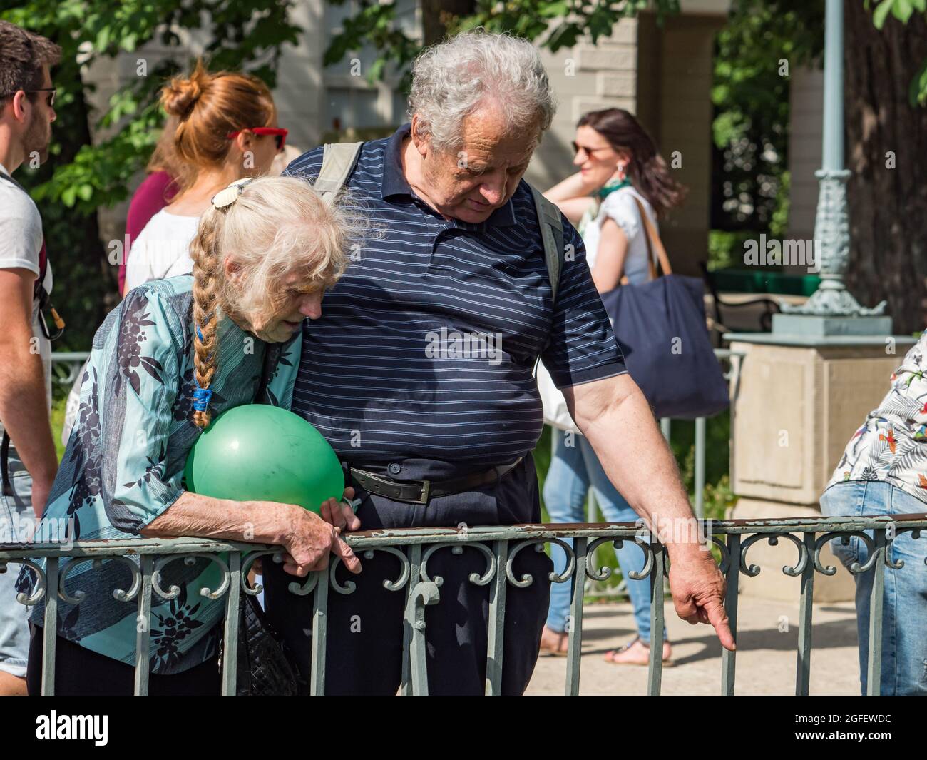 Happy elderly man and woman in the park.  Royal Bath Park. Warsaw, Poland. Seniority concept Stock Photo