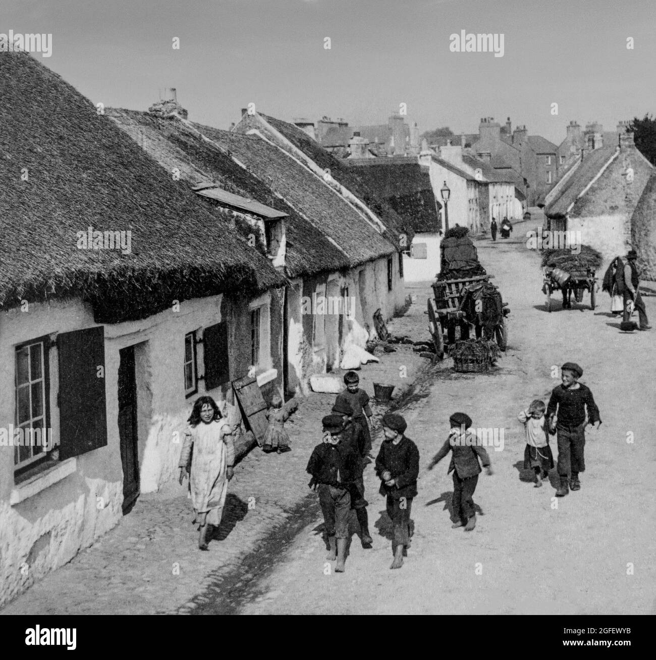 An early 20th century photograph of children in the Claddagh, formerly an Irish  fishing village, just outside the old city walls of Galway city, where the River Corrib meets Galway Bay.  During the 19th century the Claddagh attracted many visitors, but sadly the original village of thatched cottages was razed in the 1930s and replaced by council-housing. Stock Photo