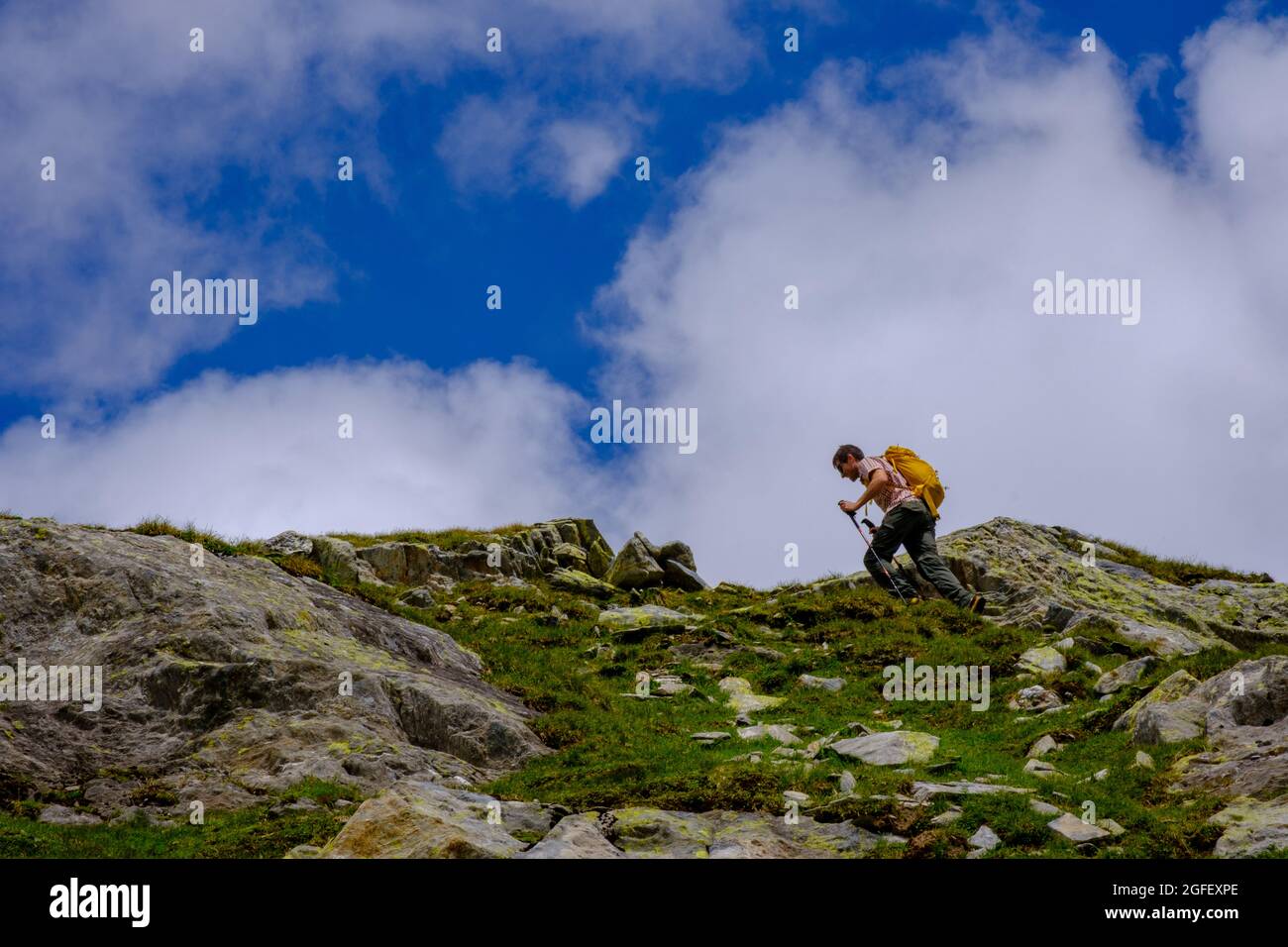 Man climbing toward the summit Stock Photo