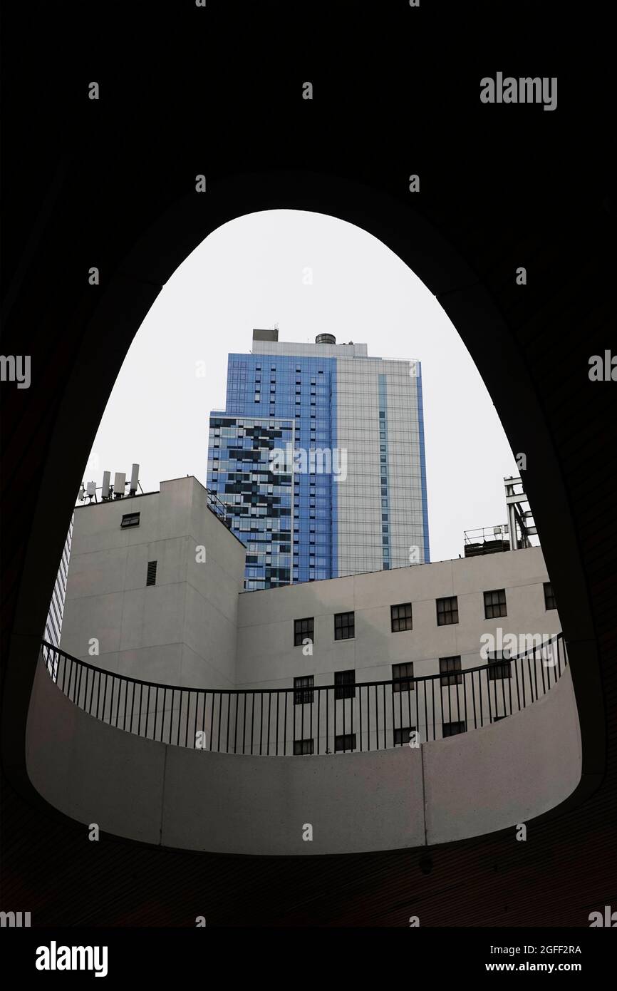 buildings in downtown Brooklyn through courtyard opening abstract NYC Stock Photo