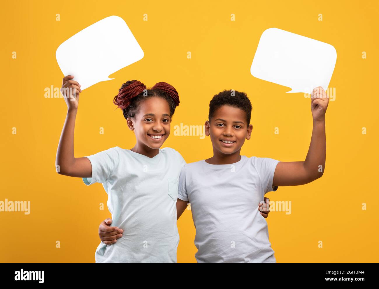 Positive afro-american brother and sister with communicative bubbles ...