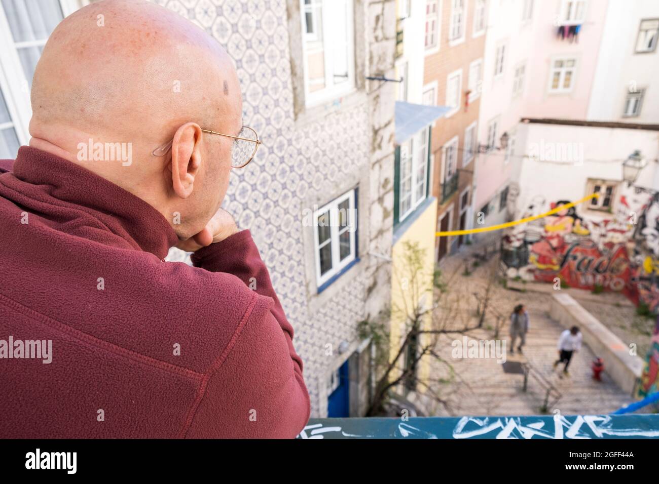 Man scrutinizes daily life in the city. Lisbon, Portugal Stock Photo