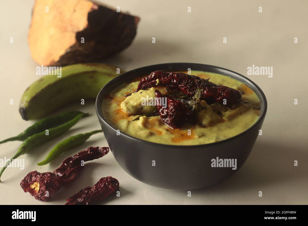 A cumin flavored yogurt based side dish with raw banana and elephant yam cooked in a coconut gravy. A main side dish of Onam meals popularly called Ka Stock Photo