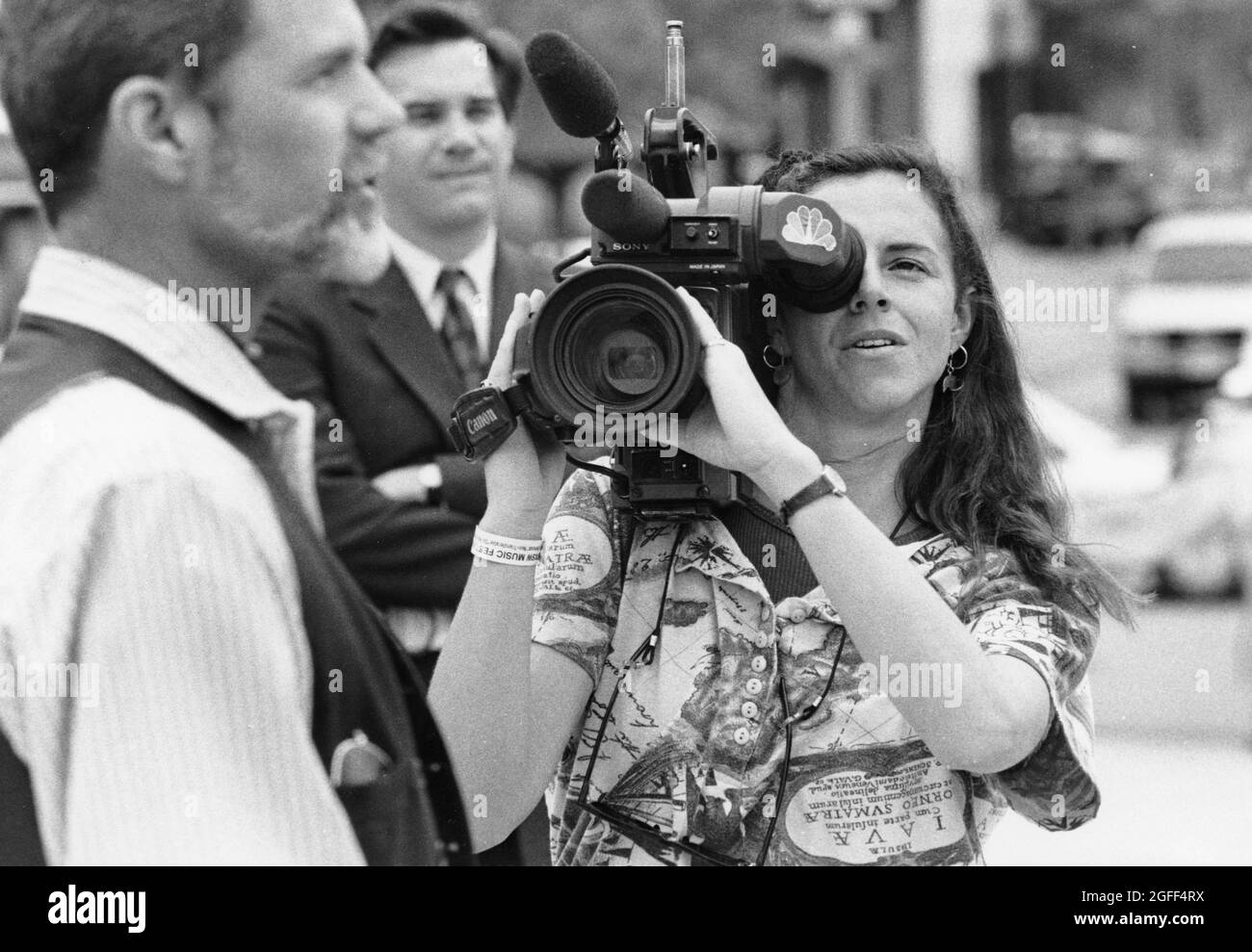 Austin Texas USA, circa 1993: Female camera operator, part of a local TV station news crew, records press conference near the Texas Capitol. ©Bob Daemmrich Stock Photo