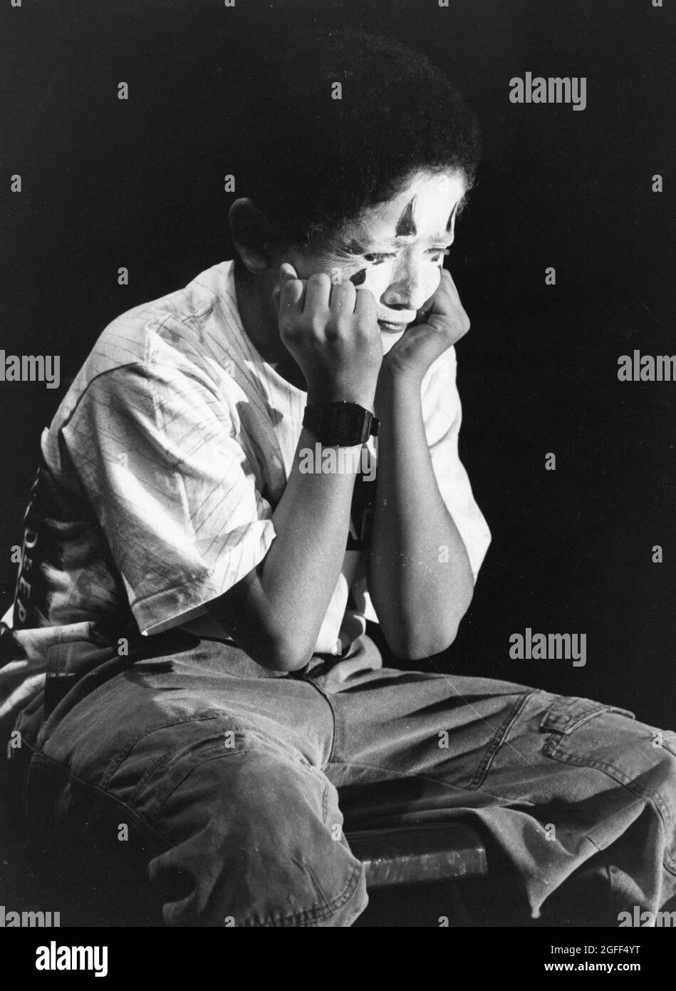 Austin Texas USA, circa 1994: Middle school student wearing face paint rehearses his role as a mime in school theater production.  ©Bob Daemmrich Stock Photo