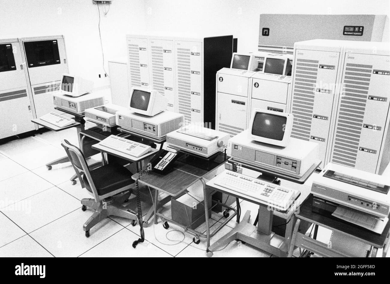 Austin Texas USA, 1990: Desktop computer terminals, printers, and a bank of mainframe computers are ready for data entry at a United States Census data processing facility during the decennial count of people living in the country. ©Bob Daemmrich Stock Photo