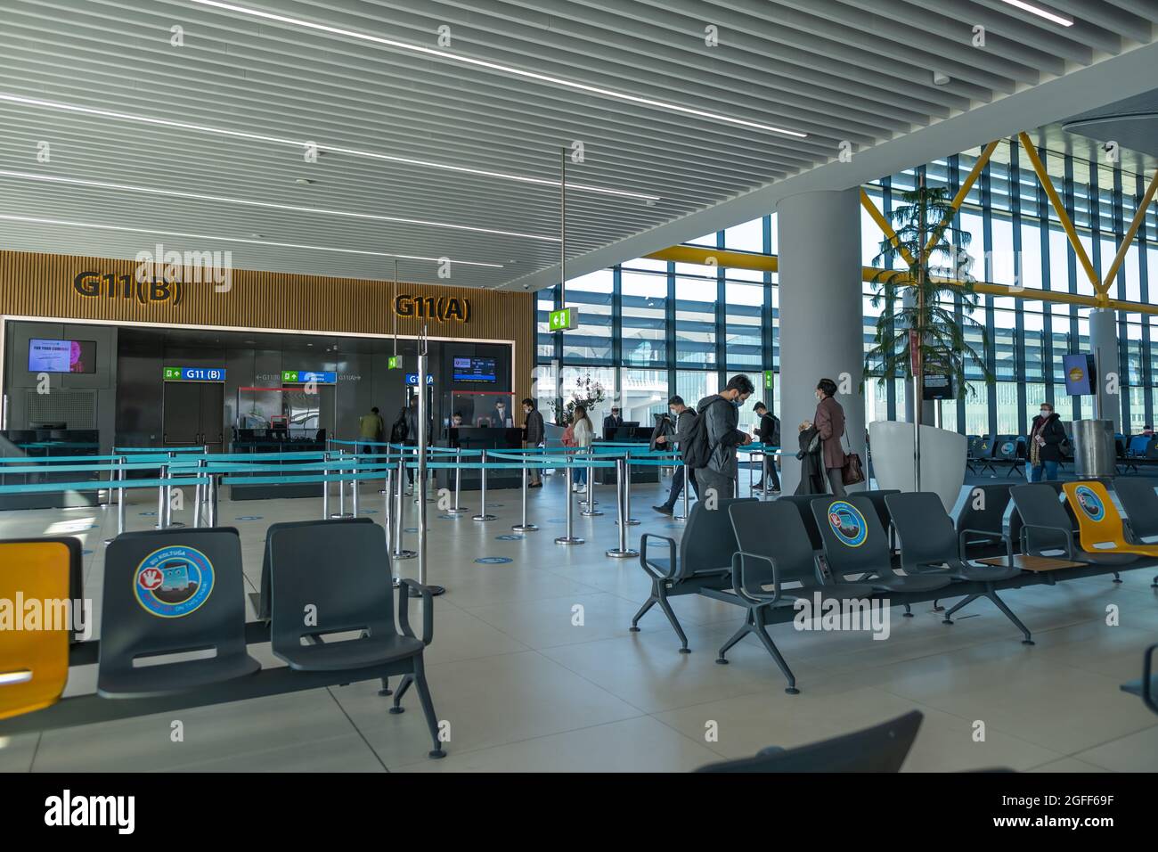 Arnavutkoy, Istanbul, Turkey - 03.08.2021: a lot of air passengers with mask wait for boarding time of airplane at the gate before takeoff time in Ist Stock Photo