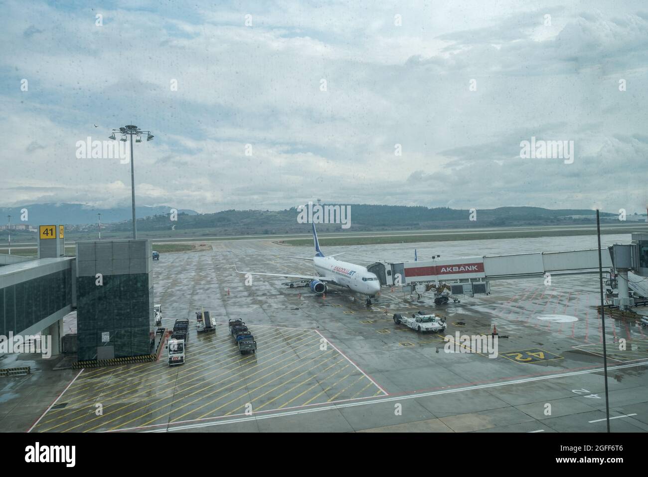 Gaziemir, Izmir, Turkey - 03.11.2021: airplane of Anadolu Jet Airlines waiting to fly in a rainy day on airdrome runway in Spring in Aydin Menders Air Stock Photo