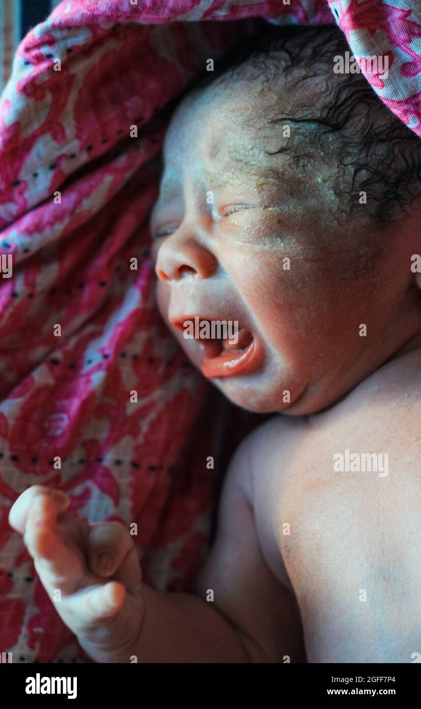 Beautiful baby boy a few seconds after the birth. Baby crying after