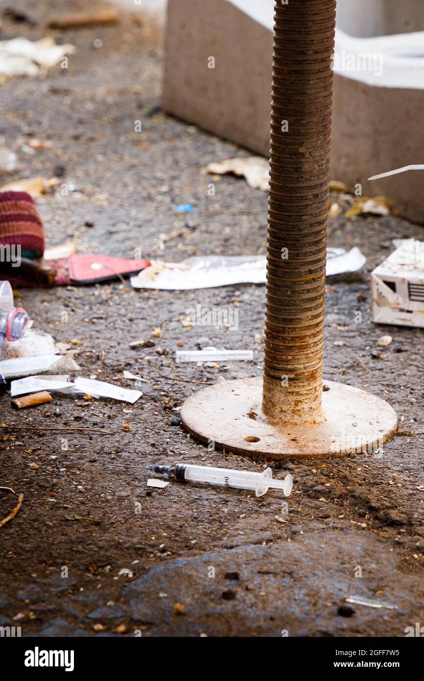 Heroin syringe on the ground, Italy Stock Photo