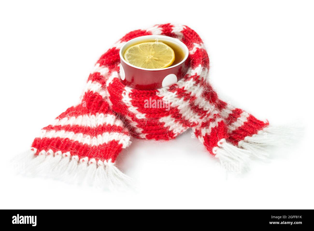 Red wool scarf, wrapped around a cup of tea, isolated on a white background Stock Photo