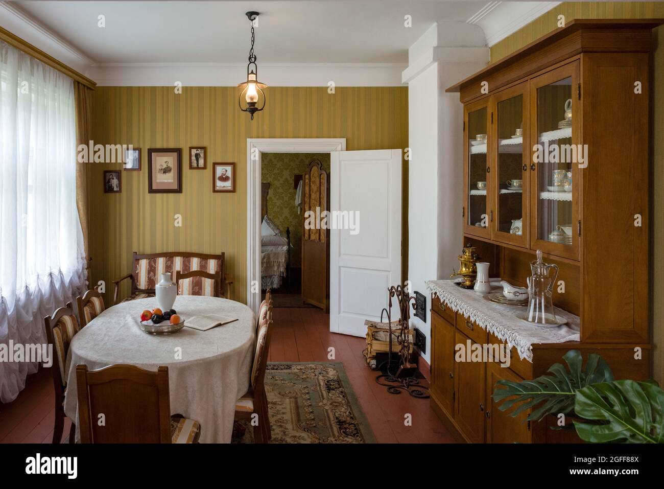 Interior of the living room of a private house of the early 20th century. Genuine firniture and decoration. Natural light, wide-angle shot. Stock Photo