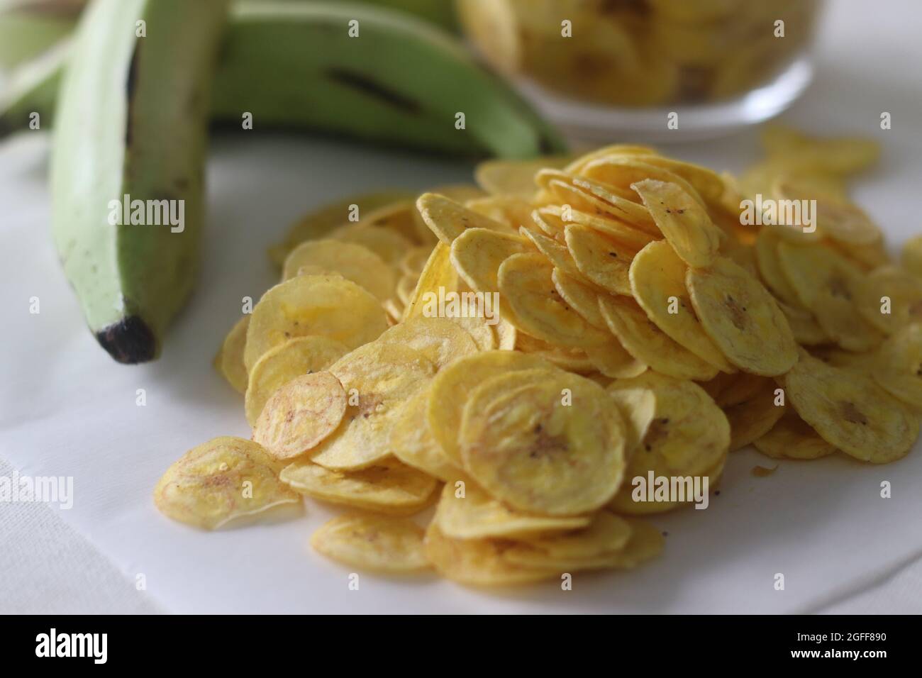 Fried banana chips made by deep frying under ripe banana slices. A main
