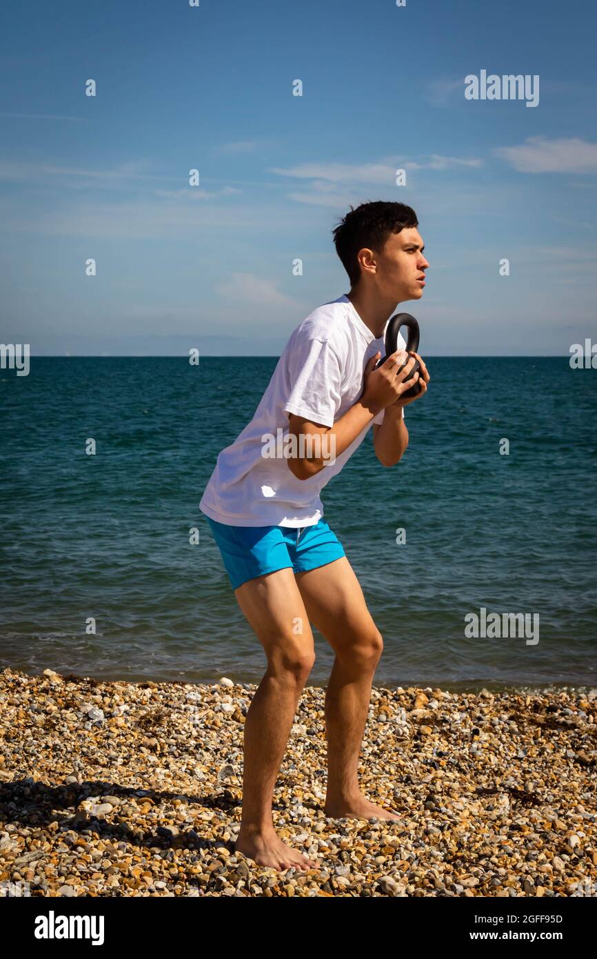 Teenage boy sitting beach looking hi-res stock photography and images -  Alamy