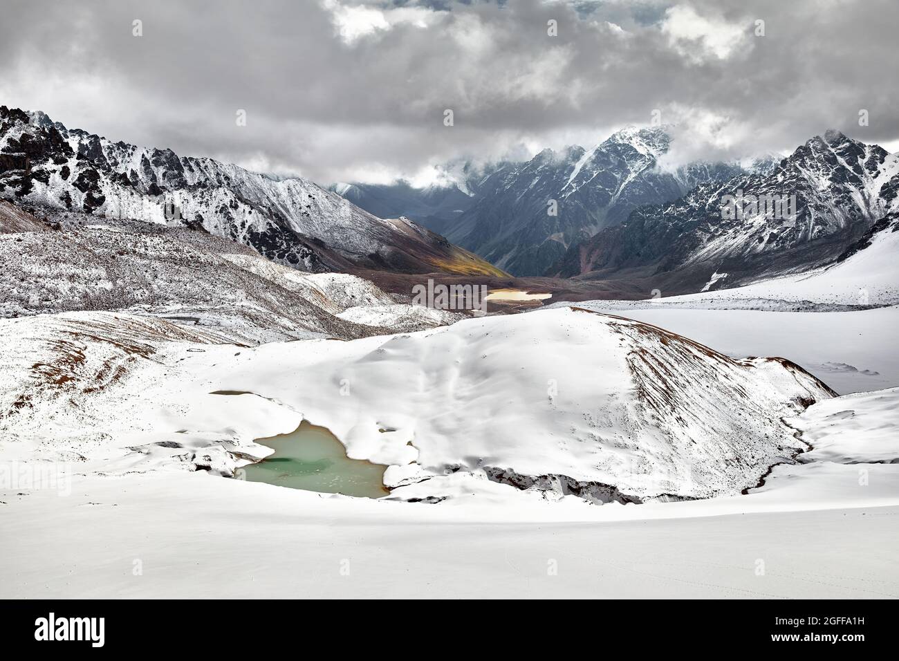 Beautiful scenery of the glacier and snow mountain lake at cloudy overcast sky in Tien Shan, Kazakhstan. Stock Photo
