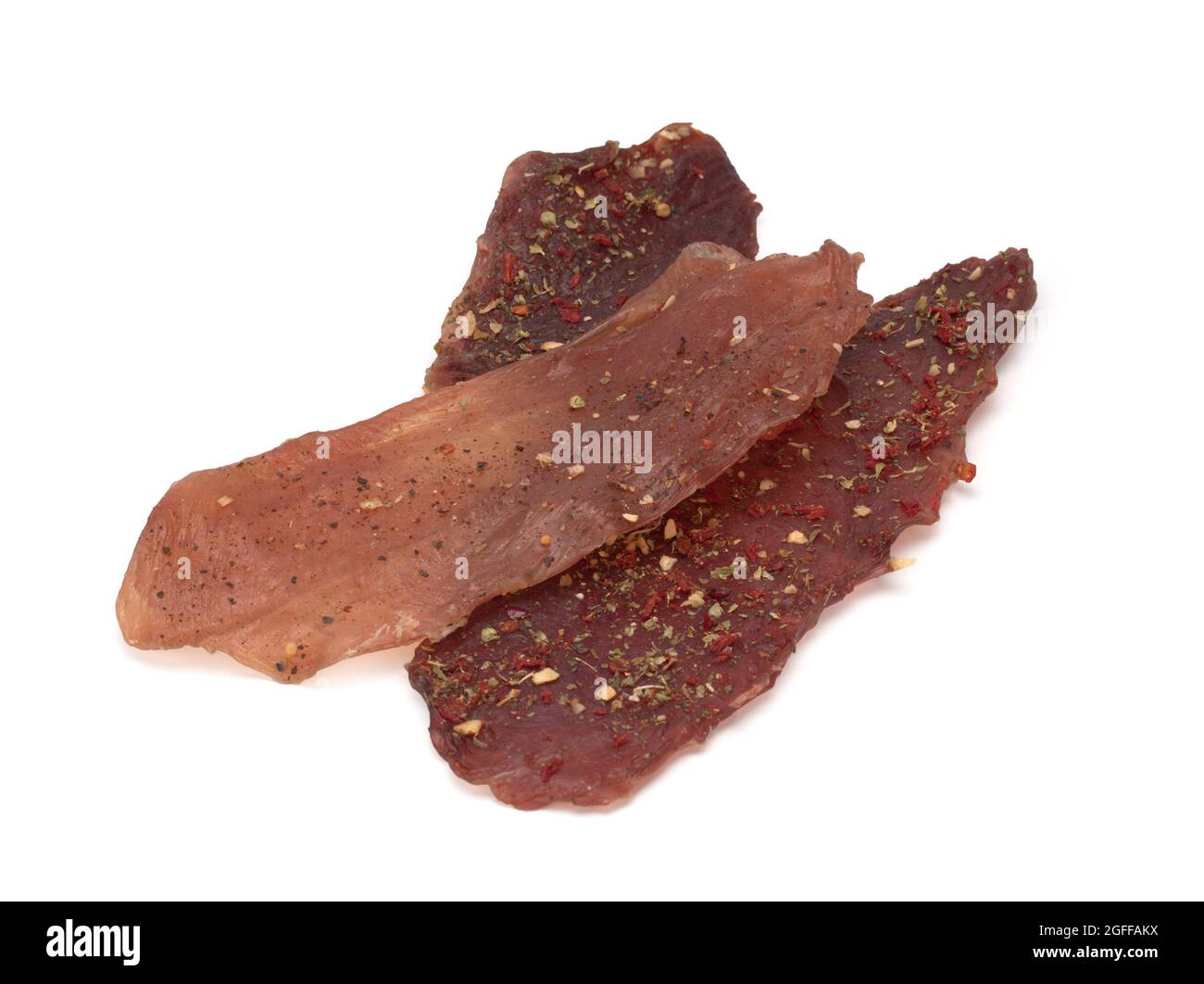 Three pieces of dried meat. Beef, pork and chicken Stock Photo
