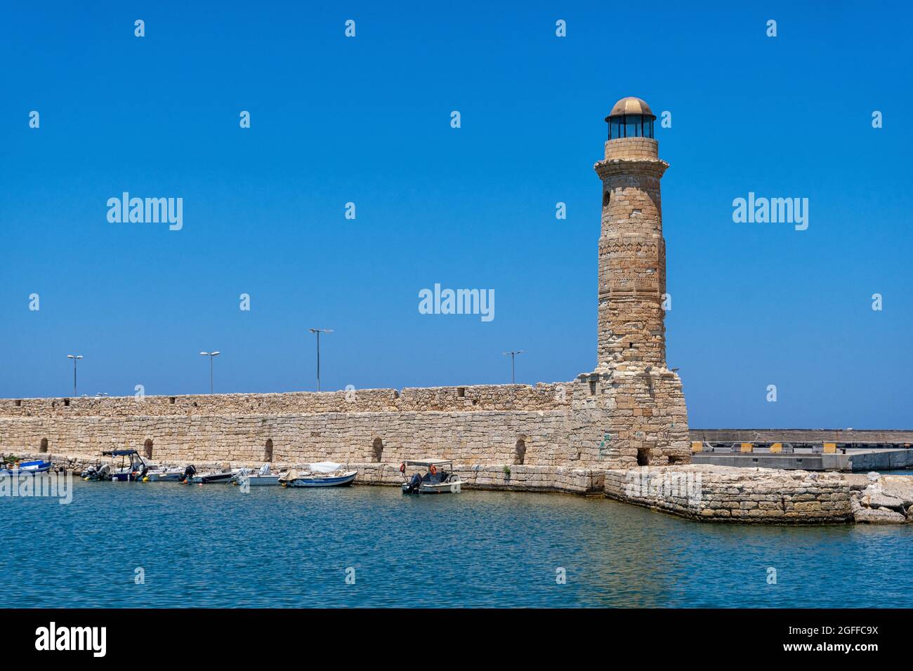 The historic lighthouse in the port of Rethymno on the Greek island of Crete Stock Photo