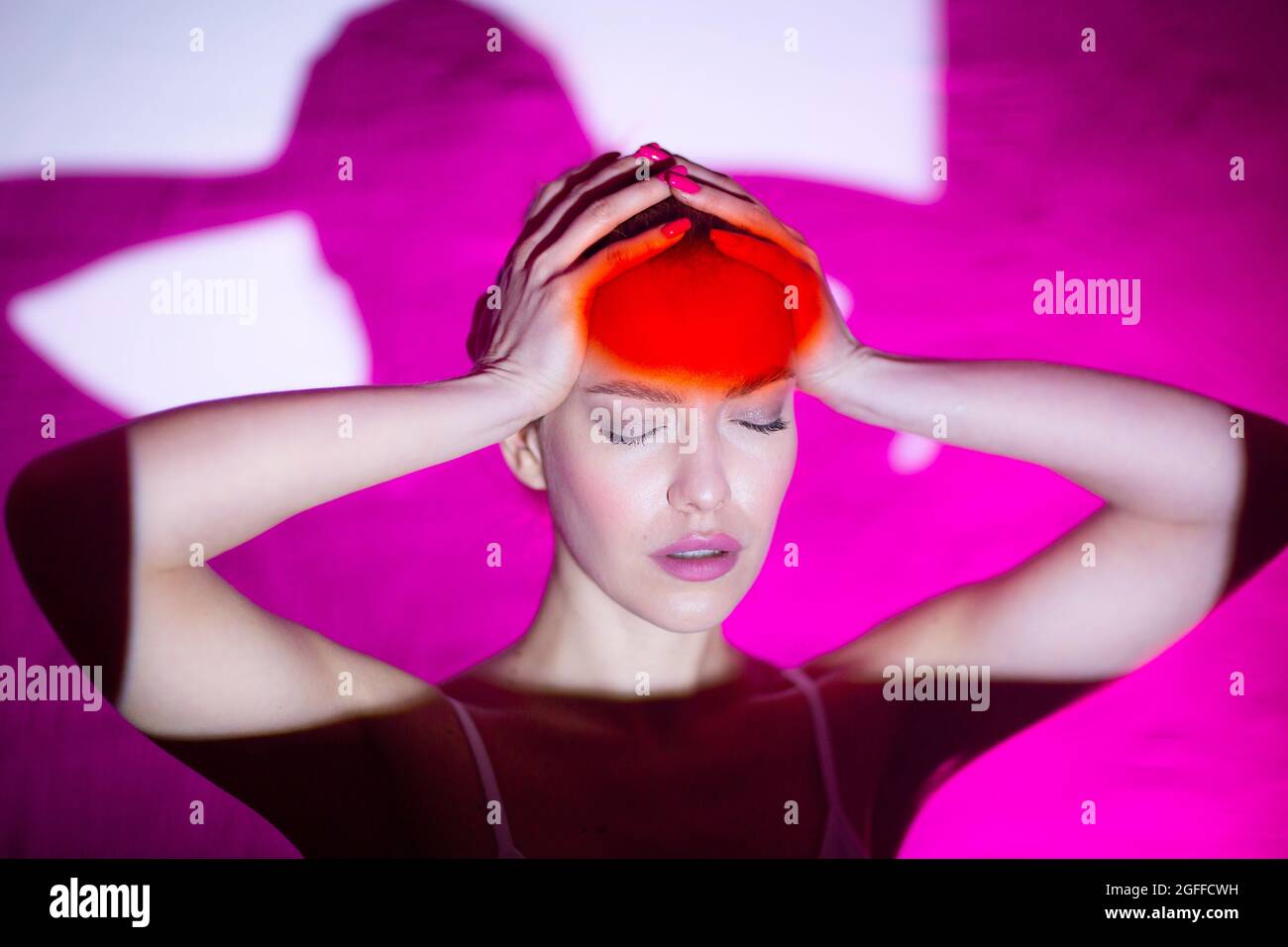 Young woman with headache and red color forehead Stock Photo - Alamy