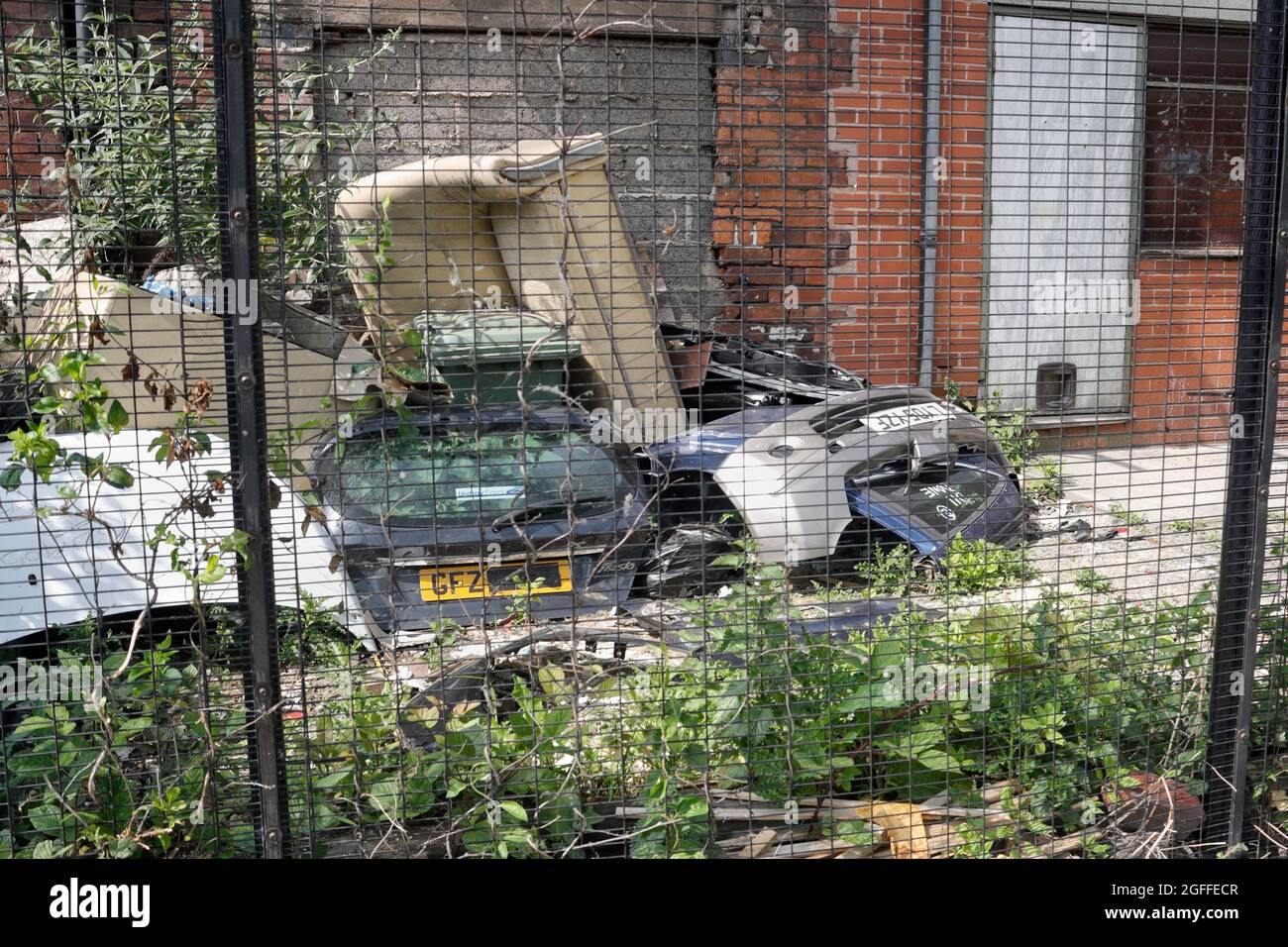 Dismantled car parts behind factory, in Attercliffe Sheffield, England