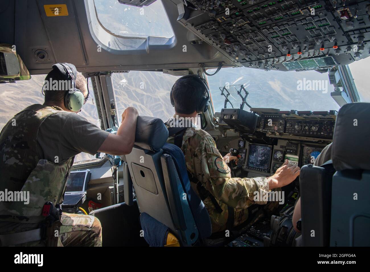 Kabul, Afghanistan. 24th Aug, 2021. U.S. Air Force pilots approach Hamid  Karzai International Airport to land in a C-17 Globemaster III aircraft to  assist in evacuating Afghan refugees during Operation Allies Refuge