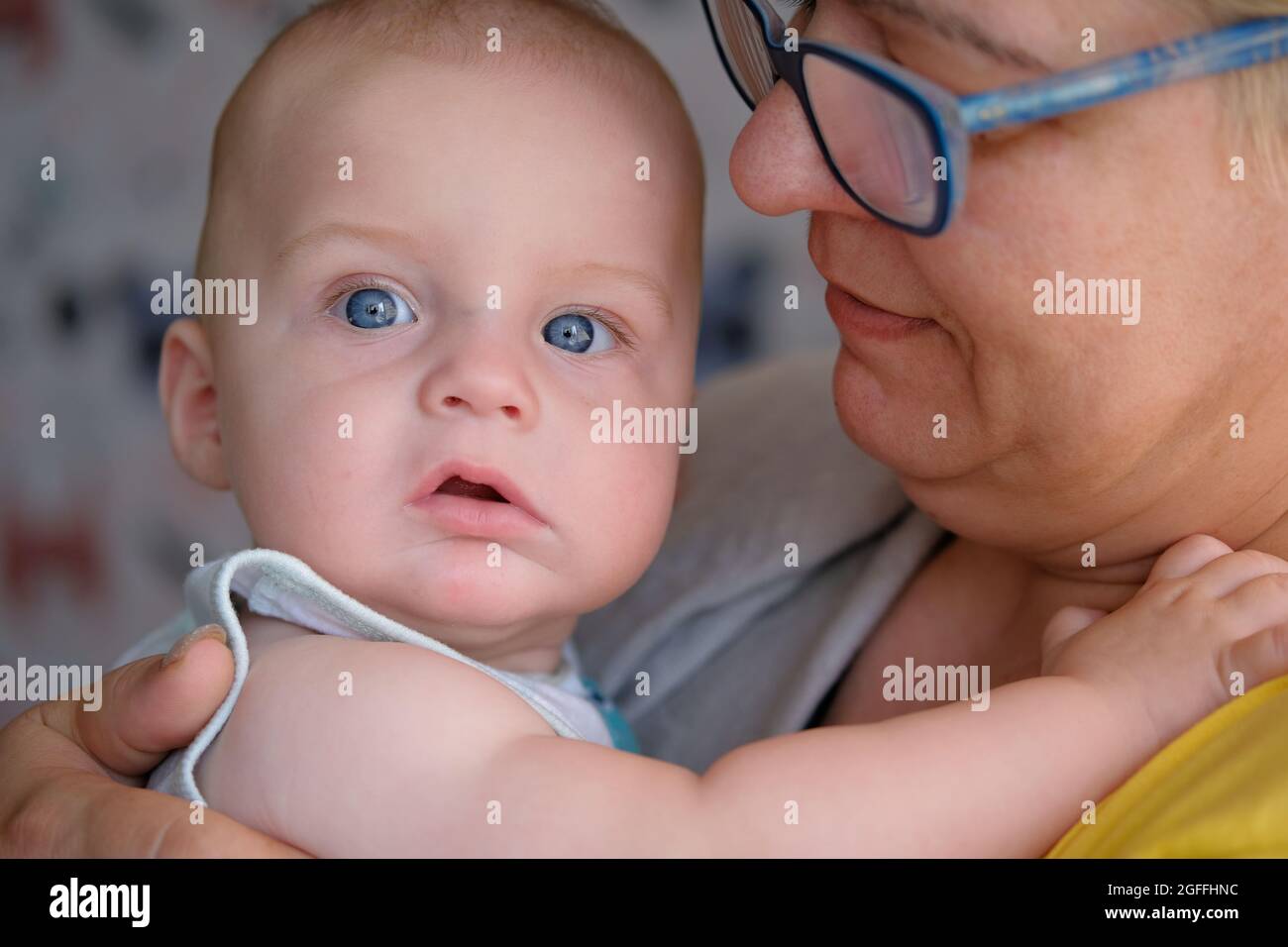 portrait of caucasian mature woman and cute baby with blue eyes Stock Photo