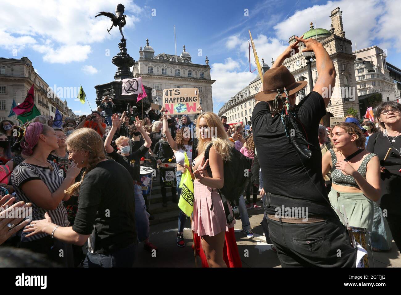 London, UK. 25th Aug, 2021. Protesters dance to the samba band before marching to Oxford Circus, during the Impossible Rebellion - Day 3. Led by Female, Intersex, Non-binary and Trans (FINT) people from Extinction Rebellion, rebels demand that government change policies to address the ecological and climate emergency and immediately stop all new fossil fuel investments. Credit: SOPA Images Limited/Alamy Live News Stock Photo