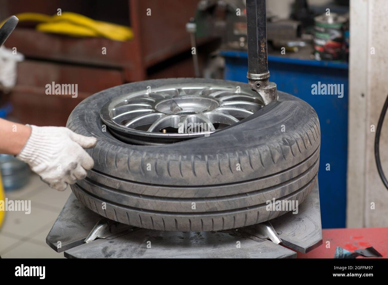 Garage car mechanic changing tyre hires stock photography and images