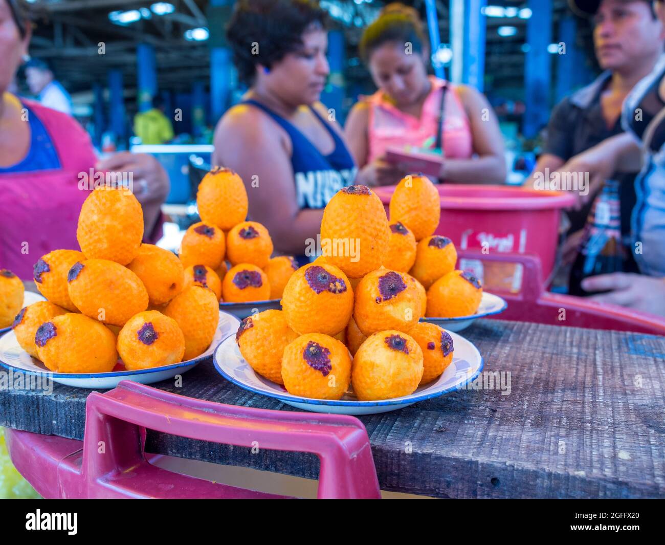 Iquitos, Peru - Sep, 2017: Exotic fruit of America : Aguaje or Moriche palm fruit (mauritia flexuosa) in Belavista bazaar in Iquitos, Peru Stock Photo
