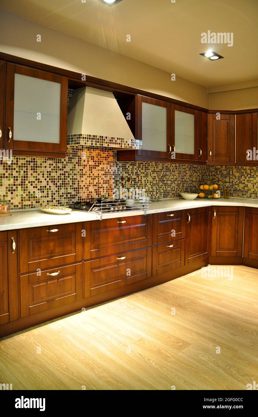 https://c8.alamy.com/comp/2GFG0CC/interior-of-luxurious-modern-kitchen-equipment-walnut-cabinets-2GFG0CC.jpg