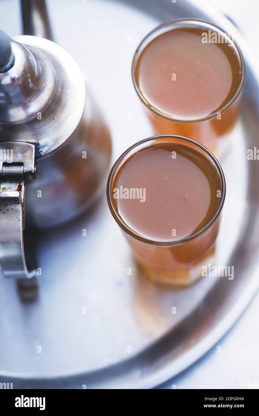 Moroccan tea, kettle and glass of fresh tea, Essaouira, Morocco Stock