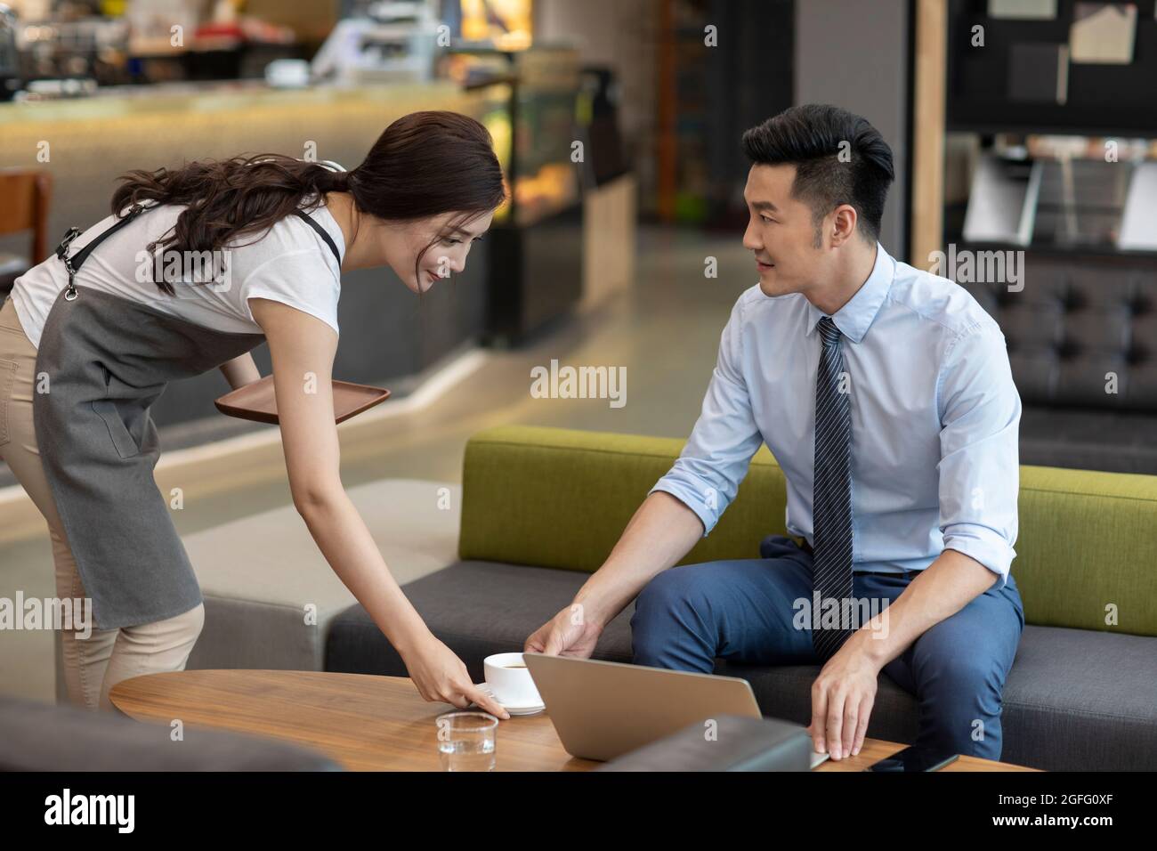 Businessman drinking coffee in café Stock Photo