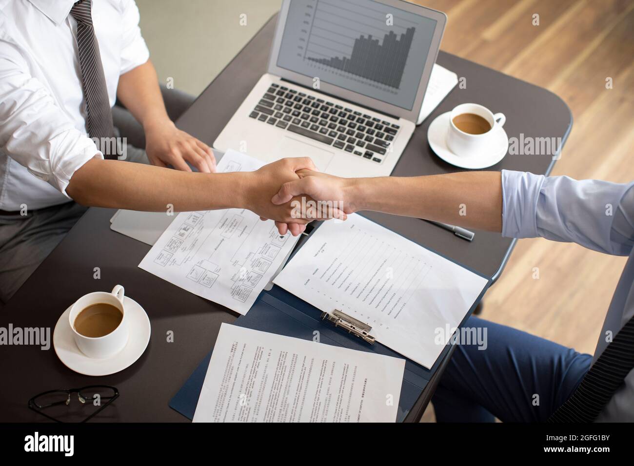 Confident businessmen shaking hands Stock Photo