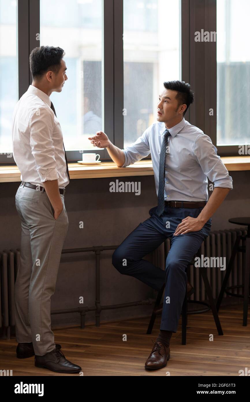 Confident businessmen talking in café Stock Photo