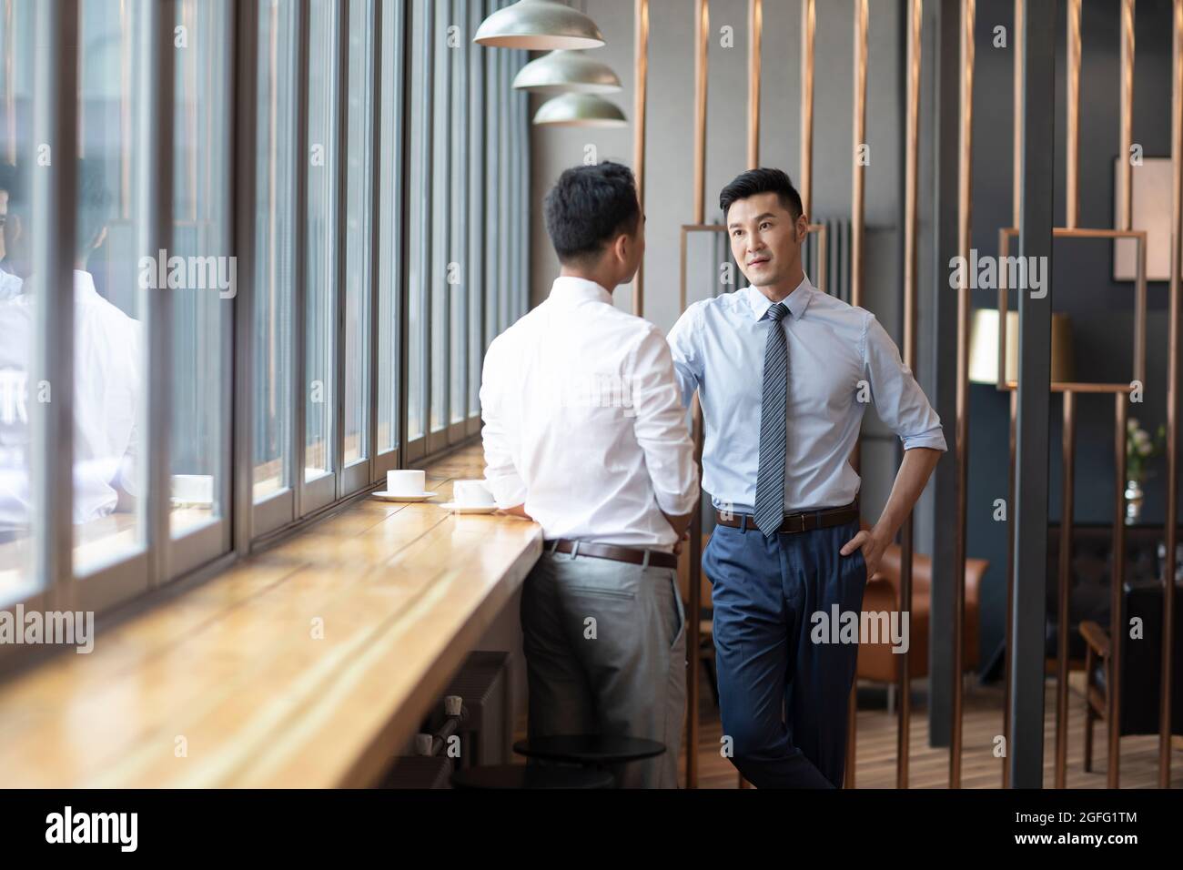 Confident businessmen talking in café Stock Photo