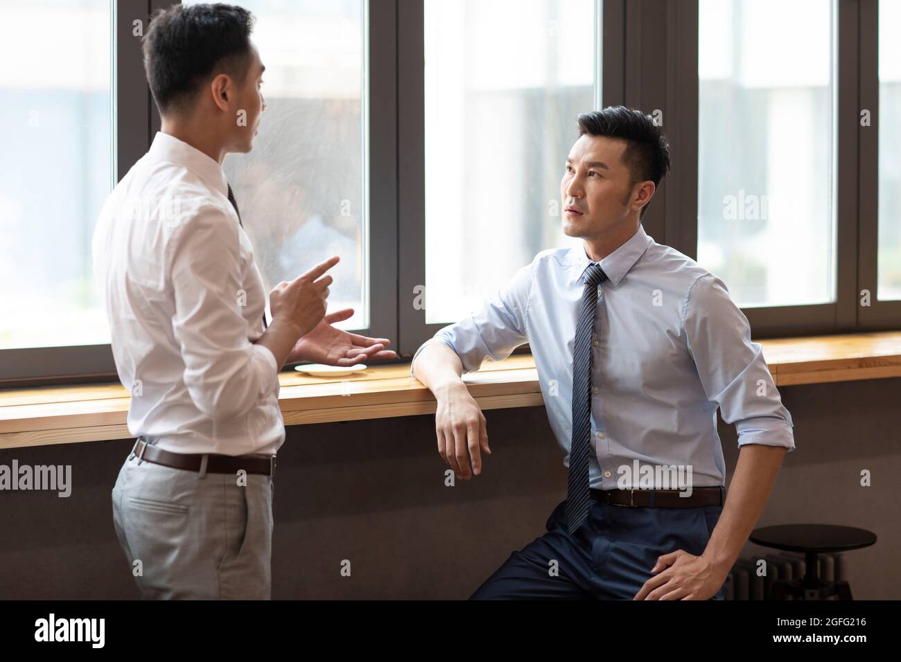 Confident businessmen talking in café Stock Photo