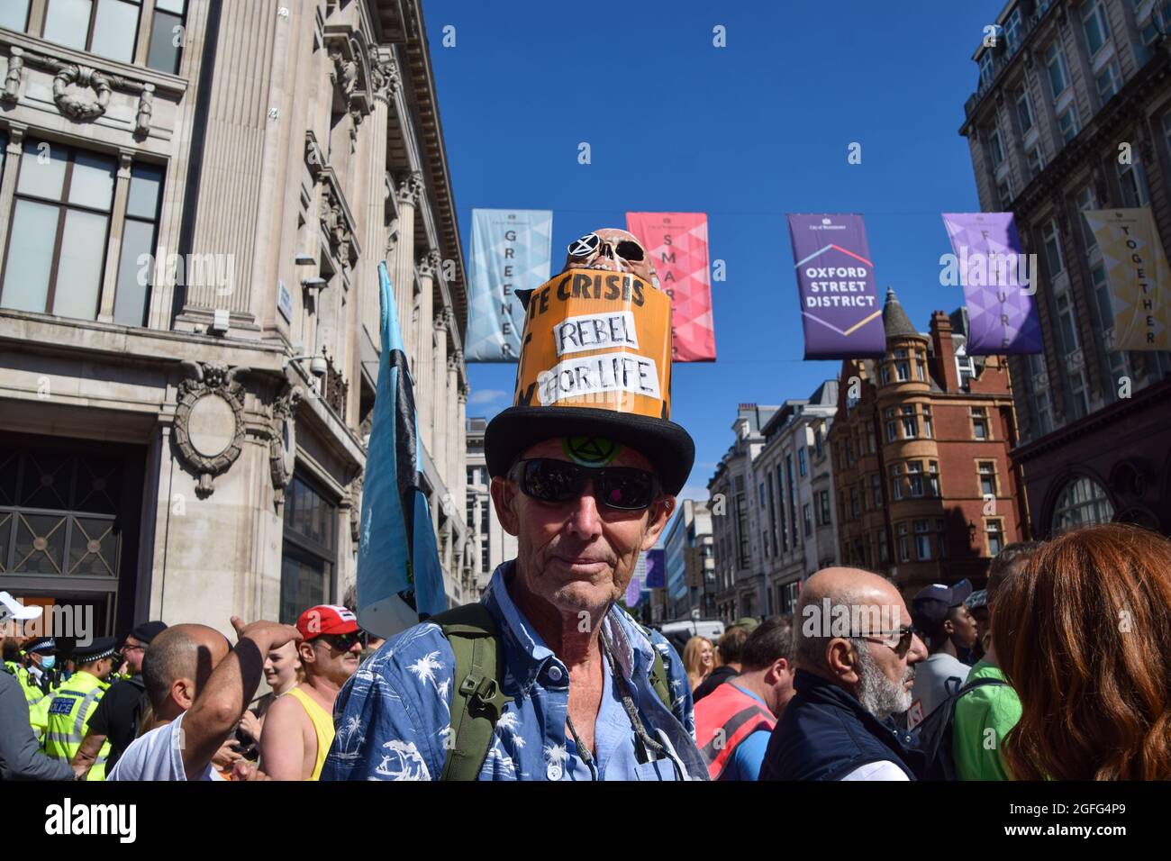 London, UK. 25th Aug, 2021. A protester wears a 'Rebel For Life' hat during the demonstration in Oxford Circus.Extinction Rebellion protesters marched through central London and blocked Oxford Circus on the third full day of their two-week campaign, Impossible Rebellion, calling on the UK Government to act meaningfully on the climate and ecological crisis. Credit: SOPA Images Limited/Alamy Live News Stock Photo