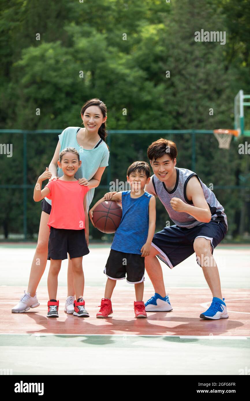 Happy young family playing basketball on playground Stock Photo - Alamy