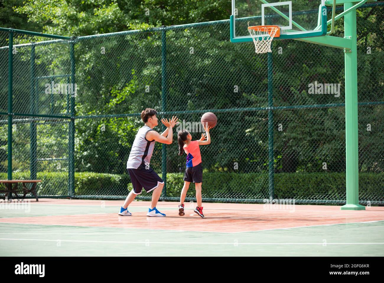 Asian family playing basketball hi-res stock photography and images - Alamy