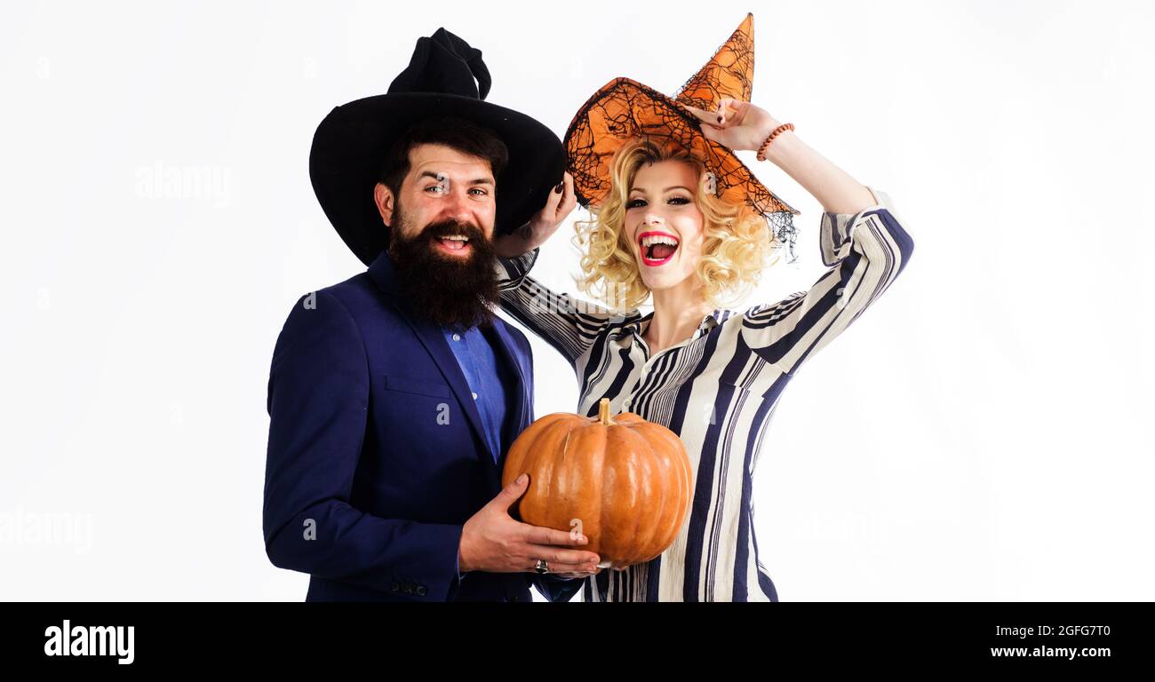 Preparation for Halloween. Happy couple in witches hats with pumpkin. Celebration and party concept. 31 october. Stock Photo