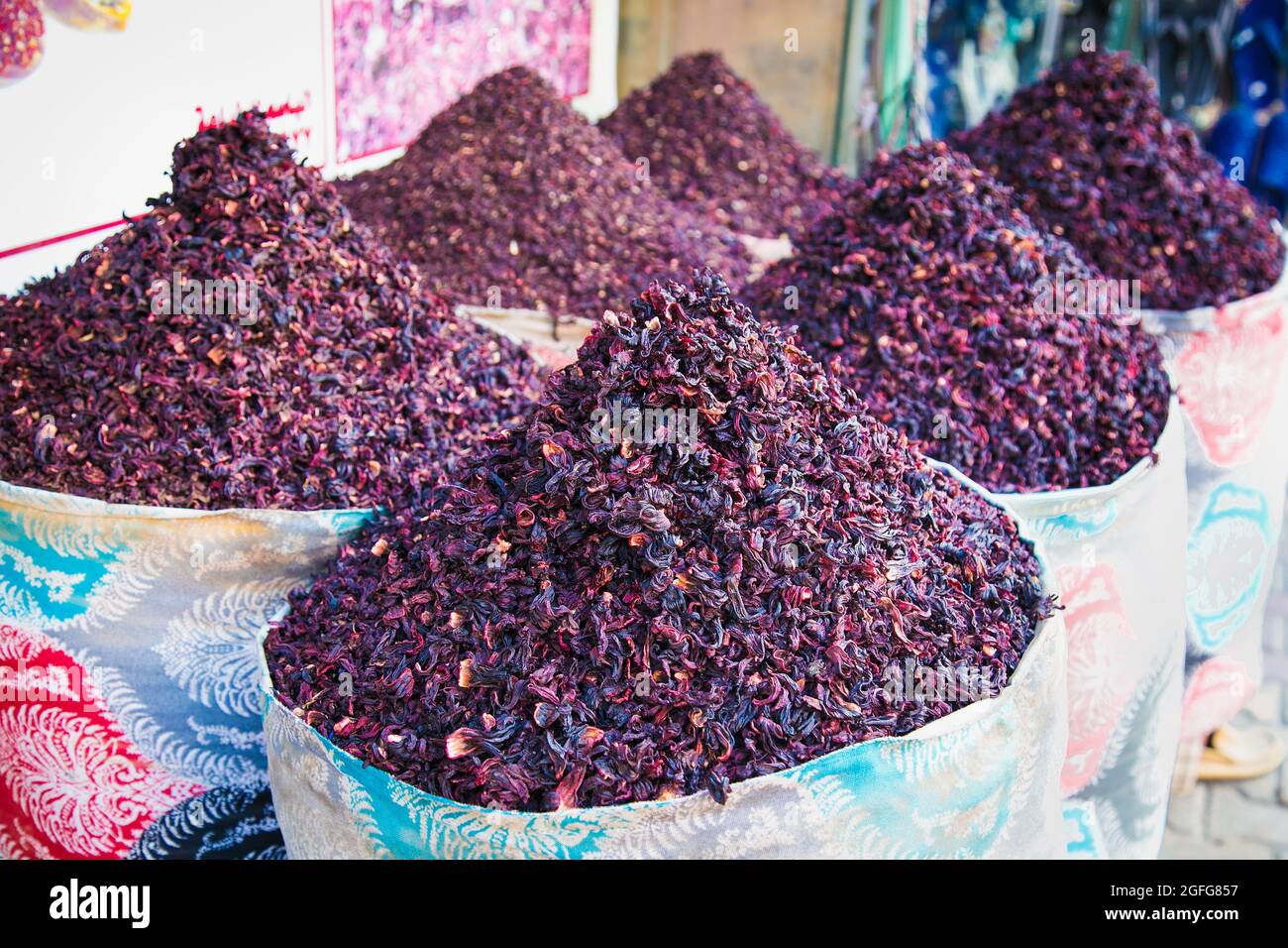 Dry karkade tea leaves in the wicker basket on the street market. Hurgada. Egypt. Dry herb hibiscus for tea in baskets. Arabic herbs on traditional ba Stock Photo